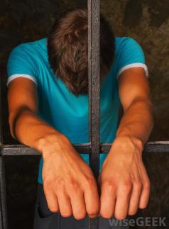 despairing-man-behind-bars